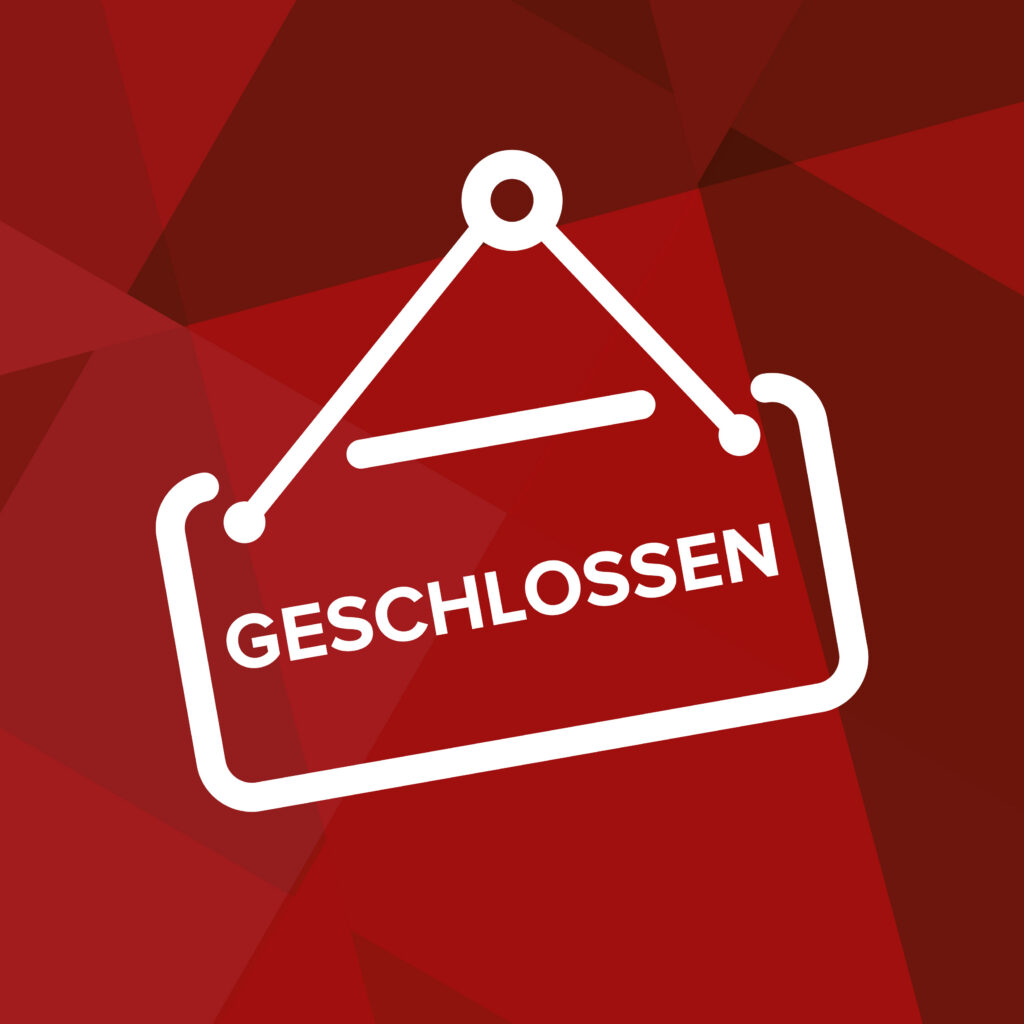 Weißes „Geschlossen“-Schild auf rotem Hintergrund als Hinweis auf die Büroschließung.